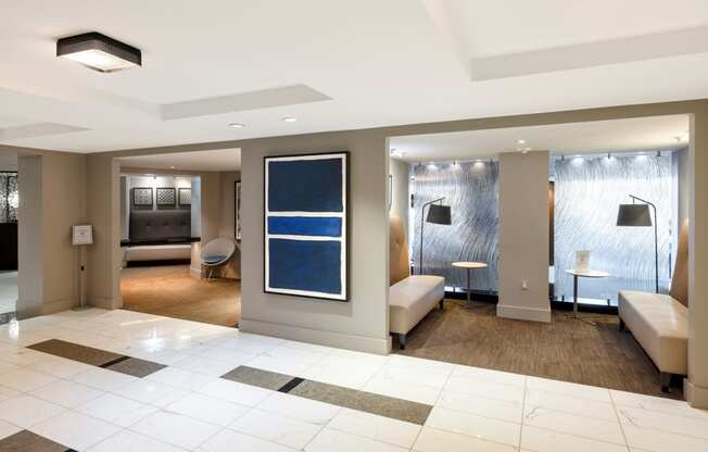 a lobby of a hotel with a reception area and a living room
