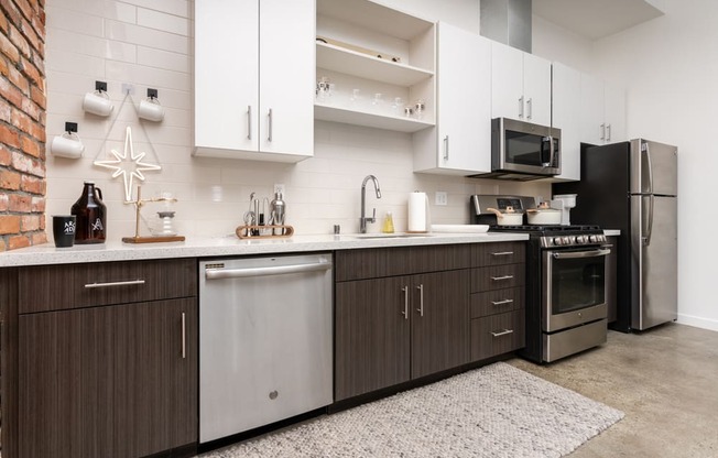 a kitchen with stainless steel appliances and white cabinets