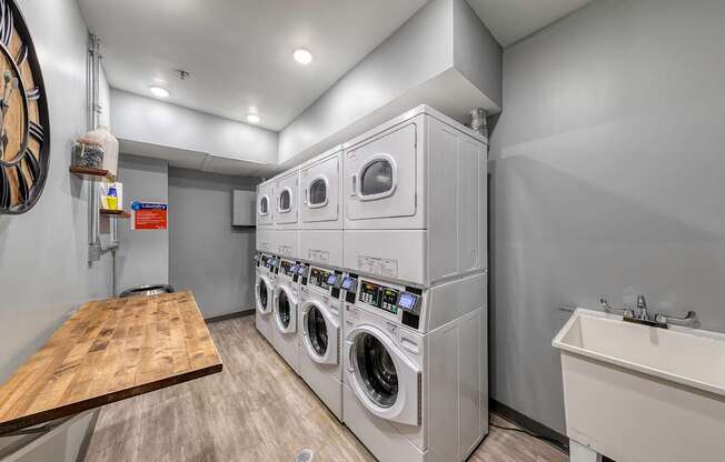 A laundry room with a washer and dryer stacked on top of each other.