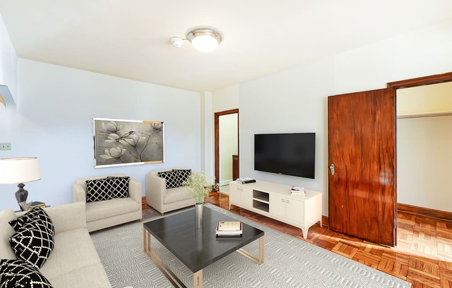 living area with sofa, coffee table, hardwood floors and view of bedroom at eddystone apartments in washington dc