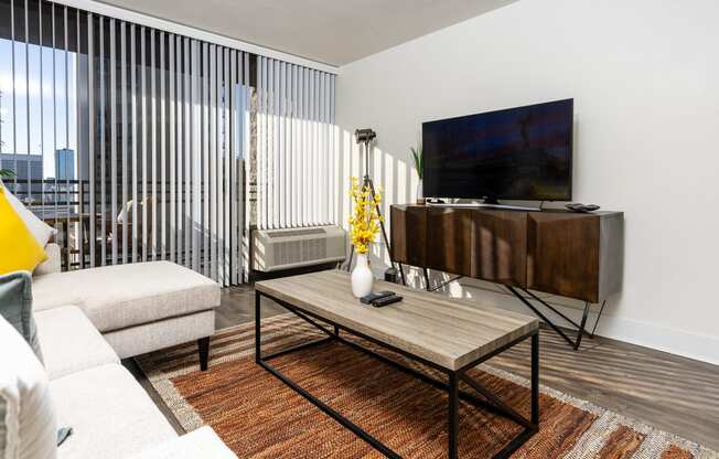 livingroom with seating, flat screen TV, entertainment center and large windows at Vera Cortez Hill, San Diego, California