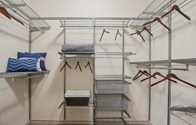 A closet with shelves and hangers.