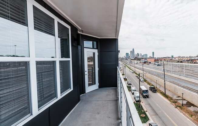 a balcony with a view of the city  at Abberly Noda Vista Apartment Homes, Charlotte, NC, 28206