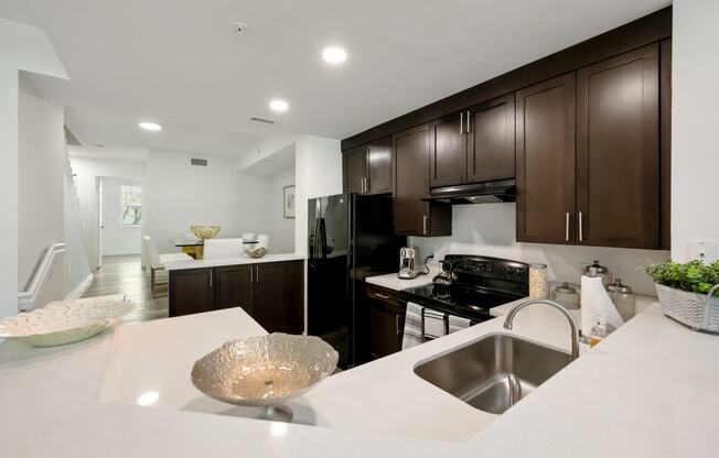 a large kitchen with a white counter top and a sink