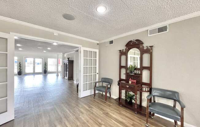 an empty living room with a wood floor and white walls at Cambridge Village Apartments, Houston, TX 77045 ? 
