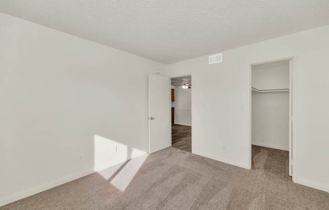 A room with a carpeted floor and white walls at Urban WalkApartments on 6th Avenue, Phoenix, AZ