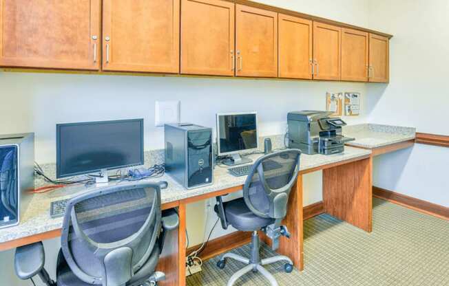 business center with two computers and two chairs