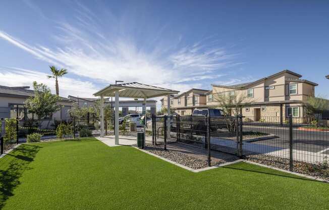 a fenced in yard with green grass and a fence at Grandstone at Sunrise, Peoria, AZ
