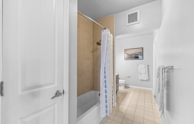 a bathroom with a shower and a toilet in a 555 waverly unit  at Harbor Pointe, New Jersey, 07002