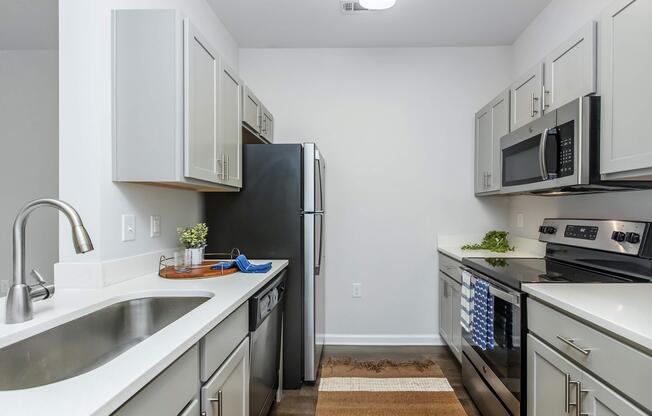 a kitchen with a stove a sink and a microwave