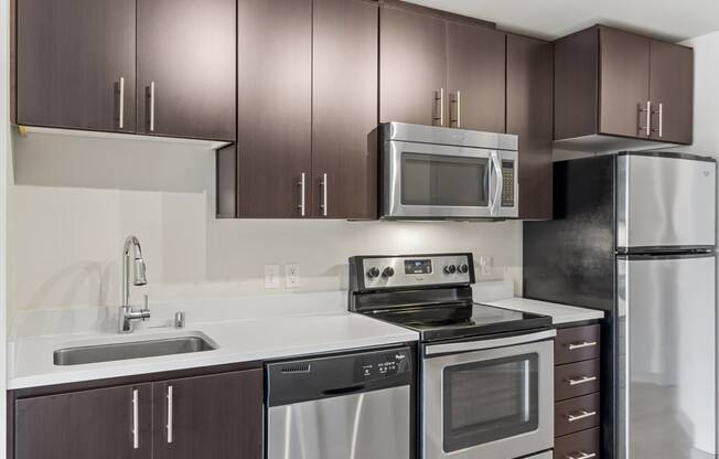 a kitchen with stainless steel appliances and wooden cabinets