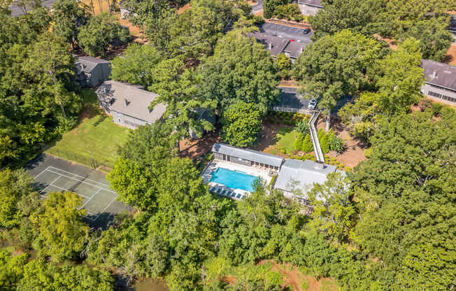 A bird's eye view of a house surrounded by trees.