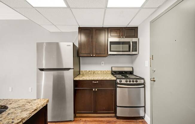 a kitchen with stainless steel appliances and wooden cabinets