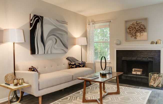 a living room with a couch coffee table and fireplace