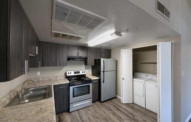 a kitchen with a stove refrigerator and a sink