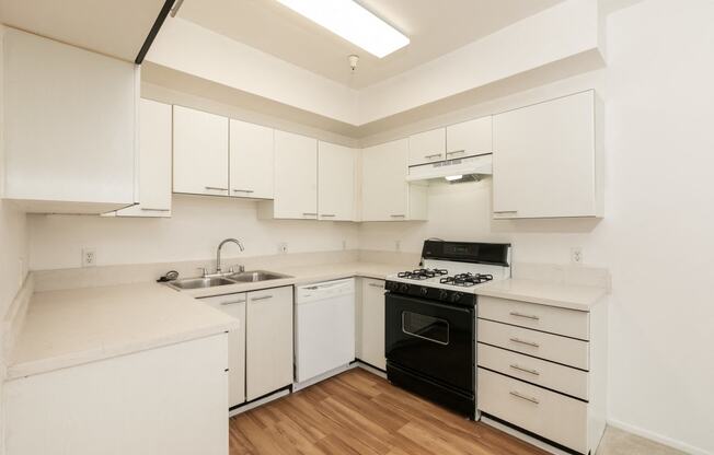 Kitchen with White Appliances and Hardwood Floors