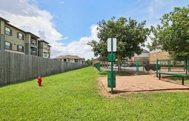 A red fire hydrant sits on a green lawn.