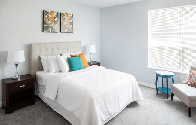 a bedroom with a white bed and colorful pillows