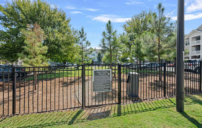 A sign in front of a fence reads "PAWELS PARK".