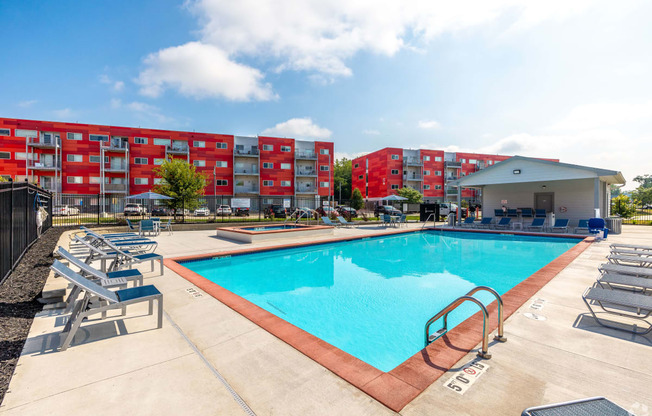 a swimming pool with a building in the background