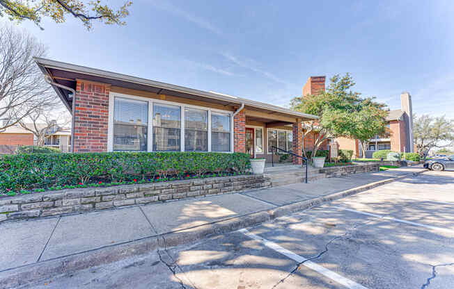 A house with a red brick exterior and a large front yard.