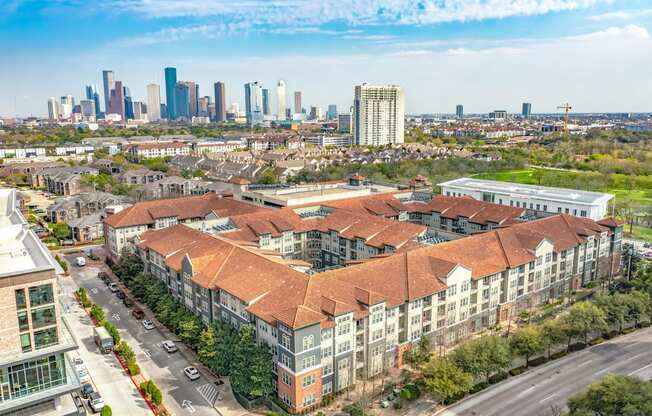 an aerial view of a building with a city in the background