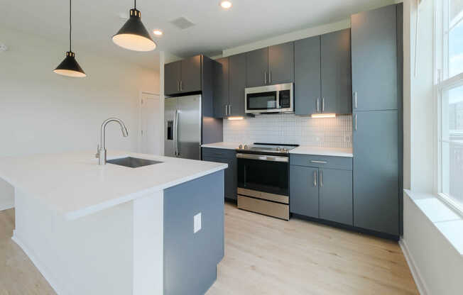 Kitchen with Stainless Steel Appliances and Dark Cabinets