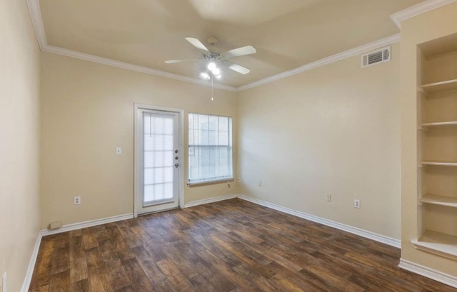 Living Room with Built-In Shelves and Hardwood Style Flooring