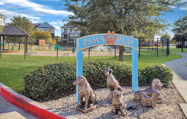 dog statues sitting outside of dog park