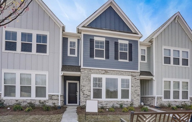 A modern house with a grey and blue exterior.