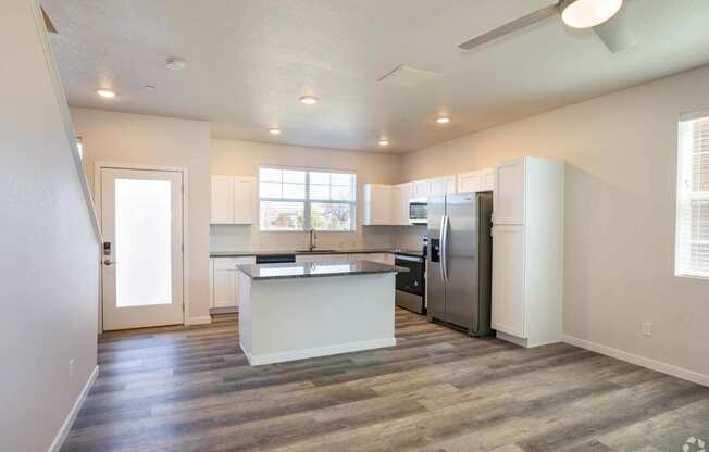 open living room with granite kitchen island at Palisade Park Townhomes, Broomfield Colorado