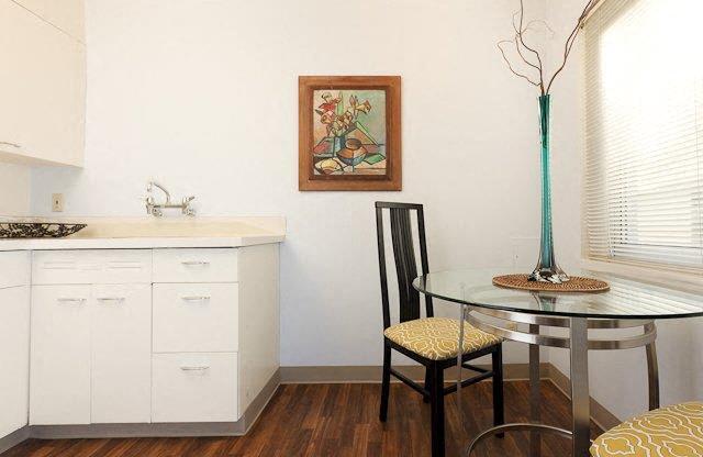 a small kitchen with a table and chair and a window