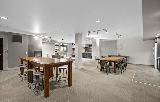 a large dining room with tables and chairs and a kitchen