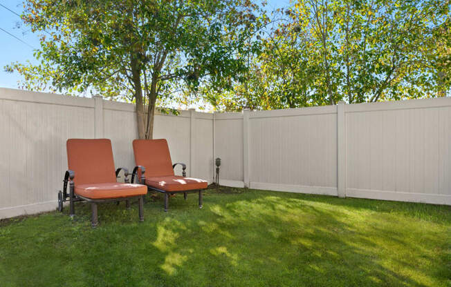 Newbury Park Apartments - Casa Linda - Fenced In Outdoor Area with Lounge Chairs And Green Pasture