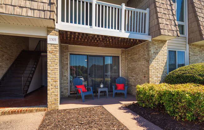 a patio with chairs outside of a building