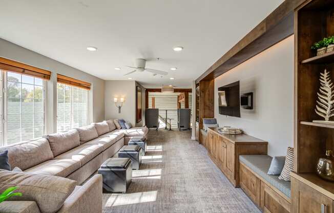 a large living room with couches and a television