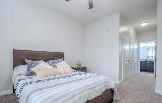 a bedroom with a large bed and a ceiling fan