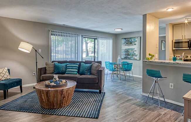 A living room with a blue couch and a wooden coffee table.