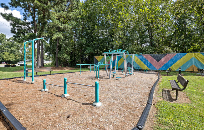 a playground with monkey bars and slides at the whispering winds apartments in pearland, tx