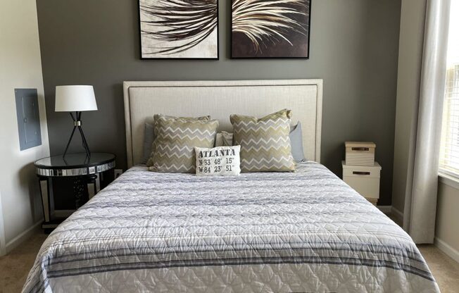 a bedroom with a bed and pictures on the wall