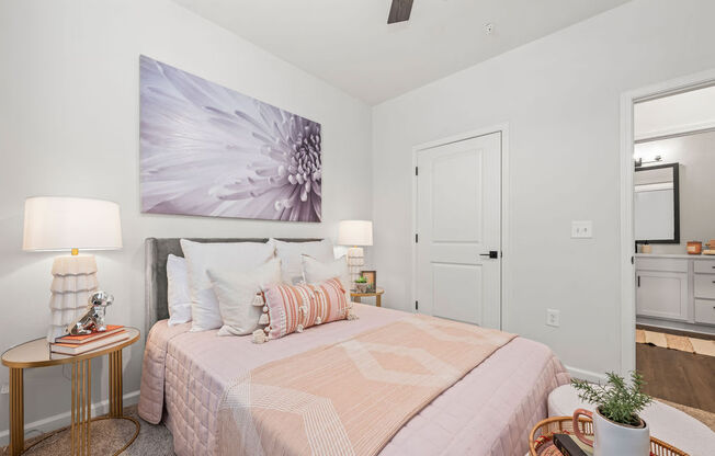 a bedroom with a bed and a painting on the wall