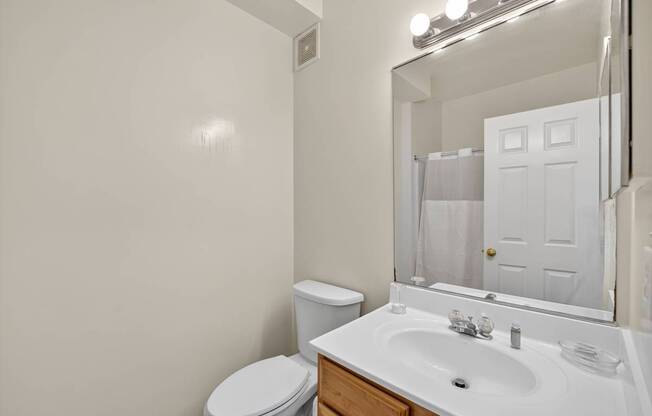 A classic style bathroom with toilet, vanity and shower