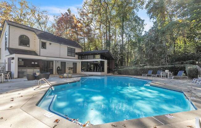 a swimming pool in the backyard of a house with a pool