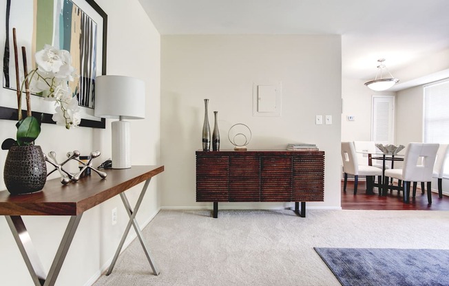 A room with a brown table and a white lamp.