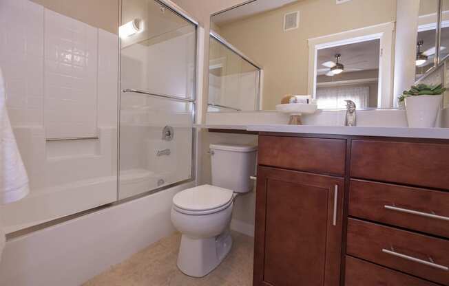 a bathroom with a toilet sink and shower