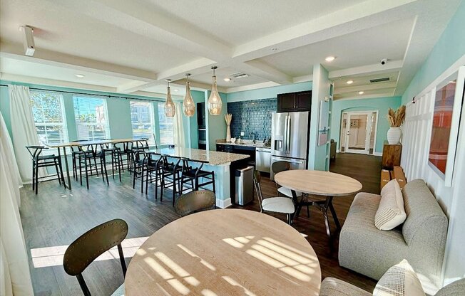 a community kitchen with a bar and kitchen appliances at flats at sundown apartments in north port florida