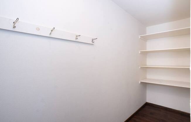a room with white walls and shelves and a white shelf on the wall. Fargo, ND Country Club Apartments