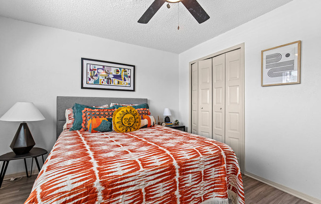 a bedroom with a bed and a ceiling fan