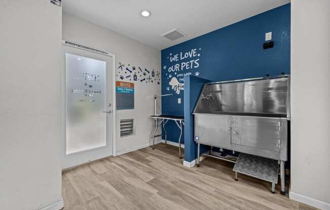 a laundry room with a stainless steel tub and a sink