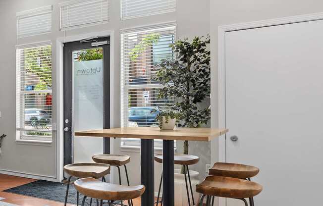 A bar area with a table and two stools.